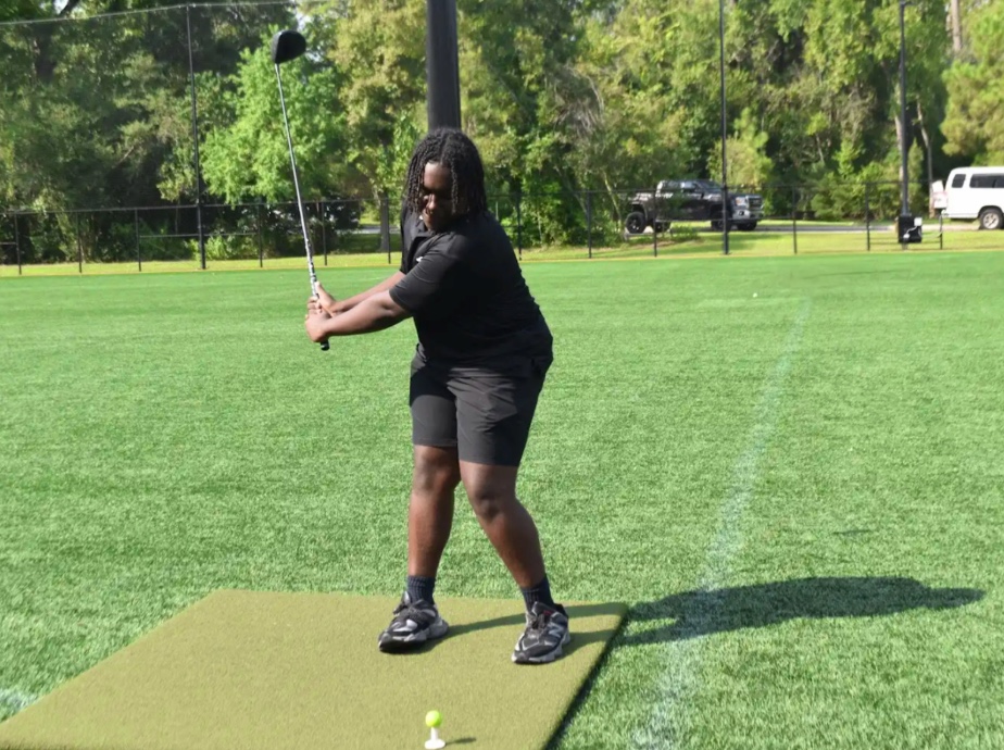 Sophomore Caden Curry practices his swing during an afternoon recreational golf practice on the Bowden Field. 
