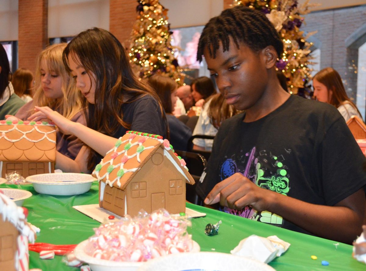 Gabriel Ngumbu, a freshman, decorates a gingerbread house at the Gingerbread Village event. Ngumbu used red and green candy to create a festive design. “I had a great time at the Gingerbread Village with my friends, and it’s definitely something I’d want to do again," he said. "It was also a great opportunity to meet members of FALB and learn more about it since I’m planning to apply in the spring."