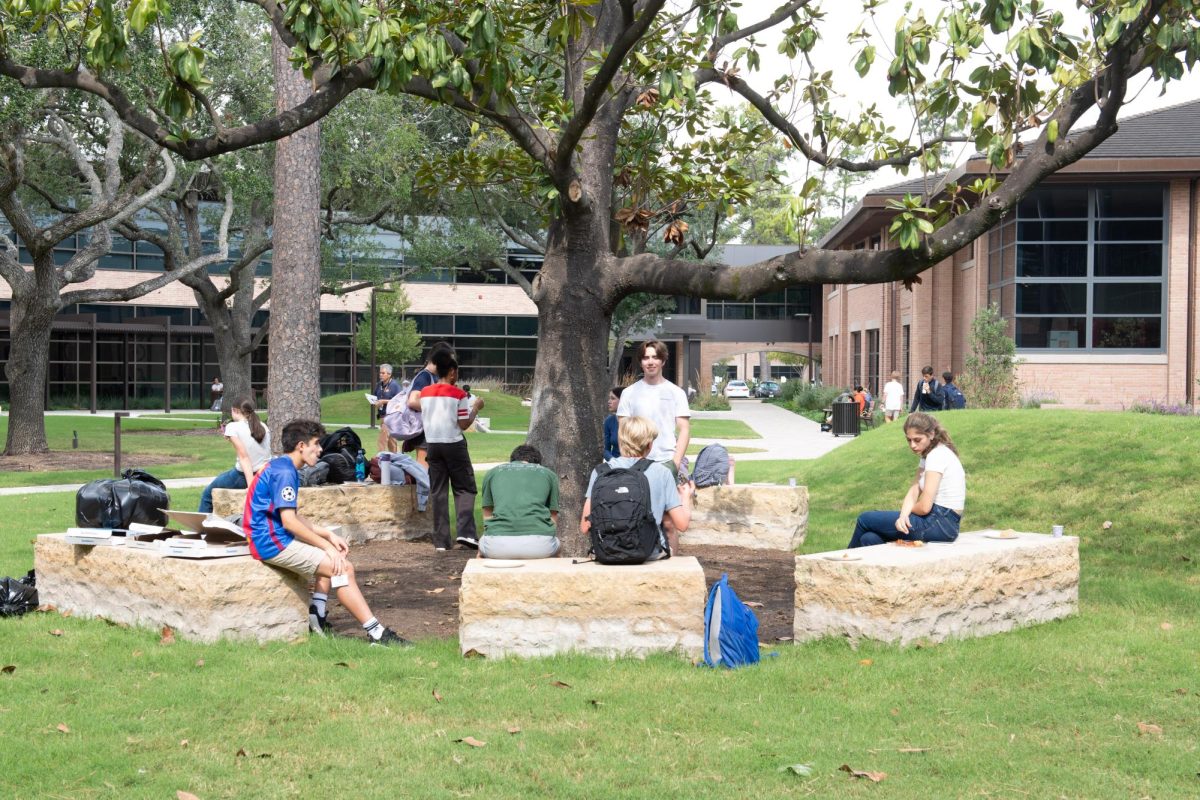 High school students chat in Central Park, a new green space within the Upper School. In the distance beyond the archway, the Temporary Upper School was also renovated for administrative offices and a Lower School expansion. 
