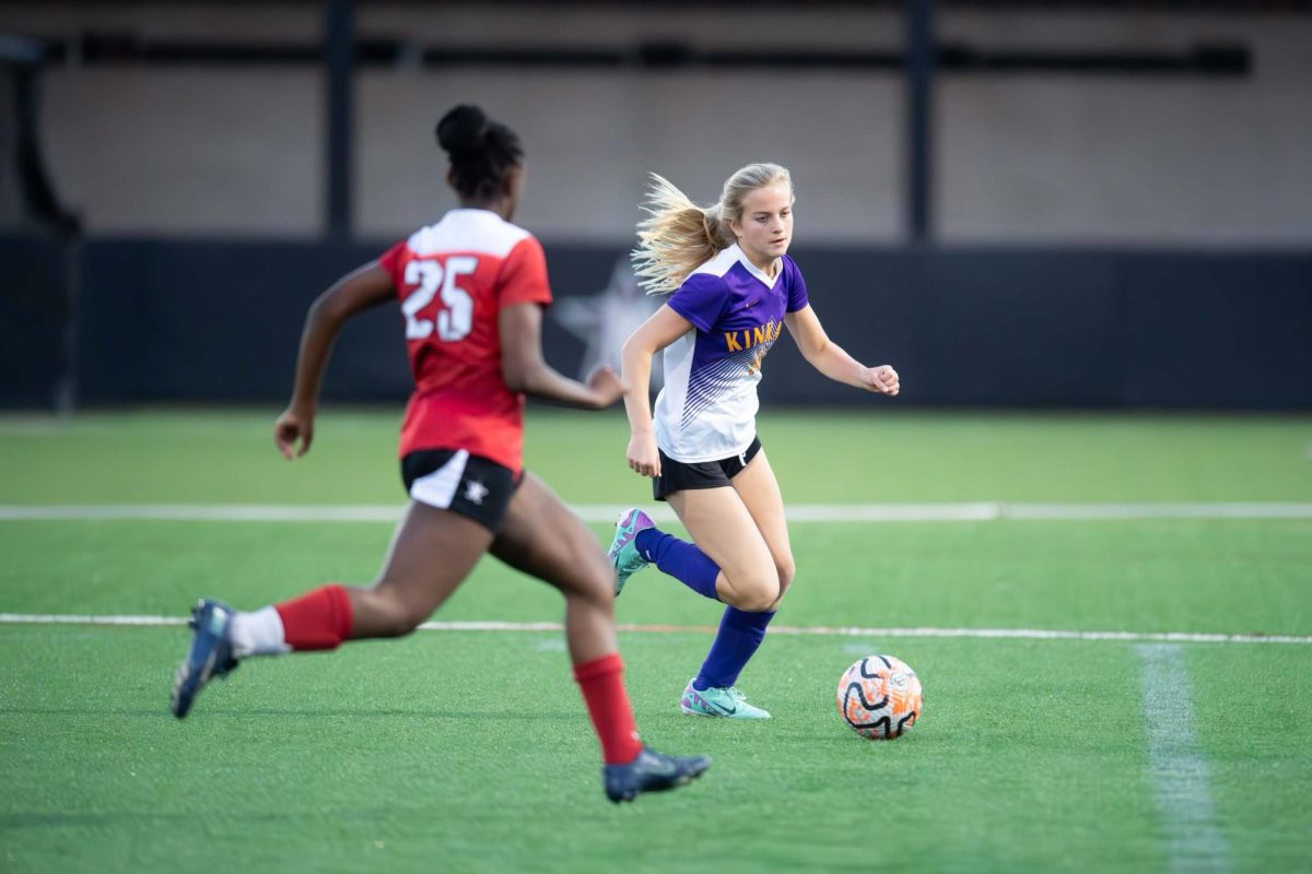Sophomore Madeline Peters works to move a ball past a defender in a JV soccer match against St. John's.